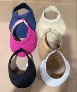 Flat lay of open top straw sun hats in six colors with elegant wavy brim design