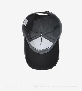 Detail view of cotton baseball cap interior featuring a metal buckle and washed fabric
