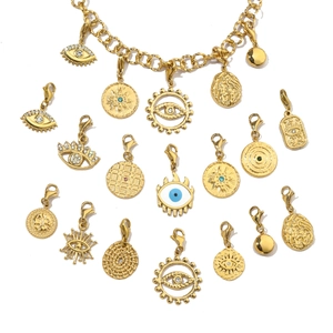 Detail of golden Evil Eye charms with blue enamel and lobster clasps for DIY jewelry