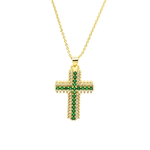 Detailed view of a gold cross pendant necklace with green and white cubic zirconia