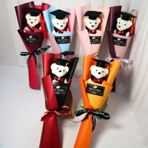 Detail of graduation teddy bear bouquets in various colors with decorative silk ribbons
