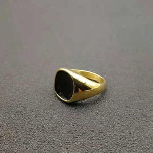 Detailed view of a gold-plated stainless steel signet ring with a black enamel inlay top
