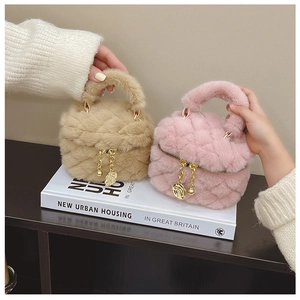 Close-up of quilted plush mini bags in beige and pink with gold flower charms