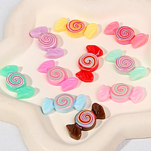 Colorful resin candy charms for DIY phone cases and hair accessories in a white dish