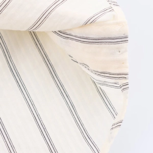 Macro shot of breathable cream-colored striped fabric with detailed linen texture