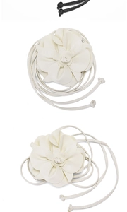 Detail of handcrafted PU leather 3D flowers on bohemian style waist rope belts in white