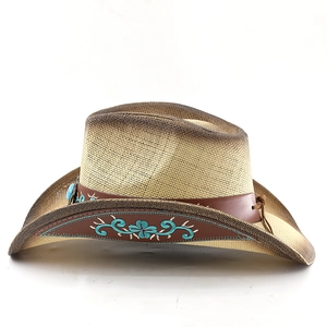 Detail of vintage straw cowboy hat with turquoise embroidery on brown leather band