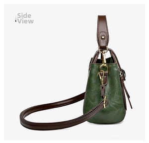 Side view of contrast color bucket bag in green pebble leather with gold-tone hardware