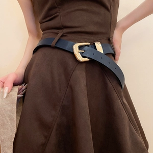 Vintage navy blue leather waist belt with gold buckle styled on a brown dress