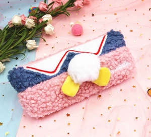 Detail of plush pencil case featuring a 3D duck tail and cute yellow webbed feet