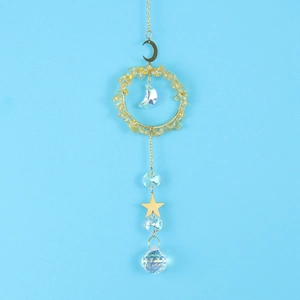 Detailed view of suncatcher with golden crescent moon and clear crystal prism pendants