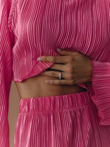 Detail of rose pink pleated fabric texture for elegant two-piece women's set