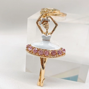 Detailed macro view of ballet girl keychain with pink rhinestones and white enamel finish