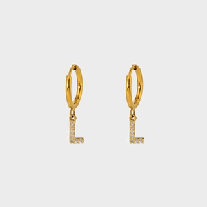Detail of gold letter L earring with micro-paved zircons and polished mirror finish