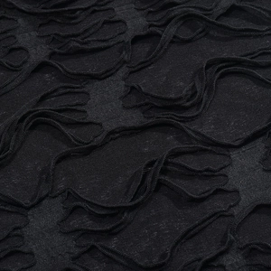 Macro view of distressed black knitted fabric with horizontal cutout fringe details