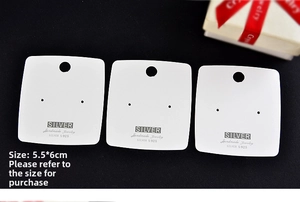Macro detail of 5.5x6cm white S925 silver jewelry display cards on black velvet