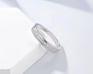 Macro view of silver S925 sterling ring featuring square-cut channel-set gemstones