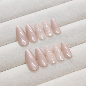 Elegant cat eye press-on nails in nude pink almond shape with shimmer gradient finish