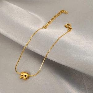 Detailed view of an 18K gold plated chain bracelet with a 3D bubble letter R pendant