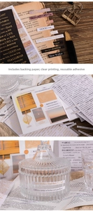 Detail of vintage gold-stamped English quote stickers on glass for DIY scrapbooking