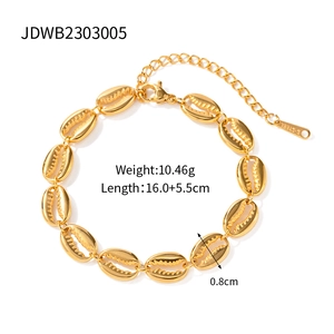 Gold-plated stainless steel Cuban link bracelet with delicate cowrie shell charms