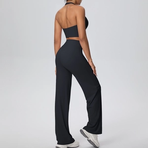 Back view of a black backless halter sports top and high-waist wide-leg fitness pants