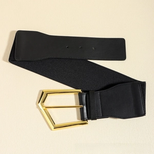 Close-up of wide elastic belt featuring a bold gold hexagonal buckle and black faux leather