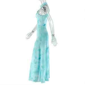 Detail of light blue sleeveless maxi dress with halter neck and abstract print