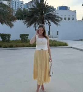 Détail d'une jupe mi-longue plissée élégante jaune vif pour un style de vacances chic d'été