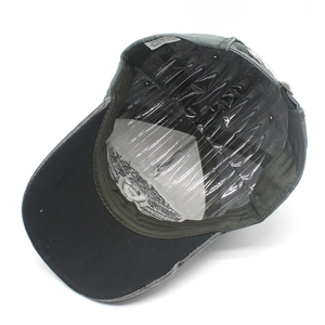 Detail view of cotton baseball cap interior showing the washing label and gray visor