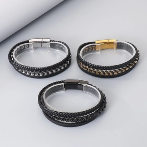Detail of layered braided leather bracelets with stainless steel magnetic clasps for men