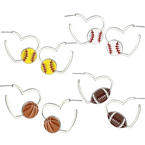 Silver heart-shaped hoop earrings set with assorted sports ball charms on white background
