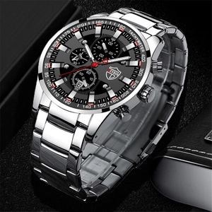Macro shot of silver stainless steel chronograph watch with calendar display and black dial