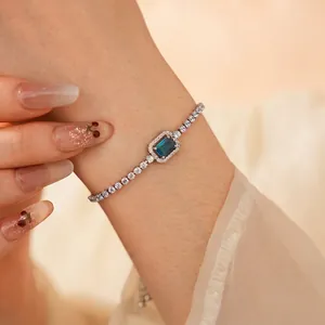 Elegant adjustable tennis bracelet with emerald cut blue stone and sparkling cubic zirconia