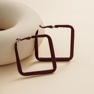 Close-up of geometric square burgundy earrings with metallic lacquer finish