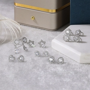 Macro shot of silver stud earrings set with sparkling white zircon in diverse shapes