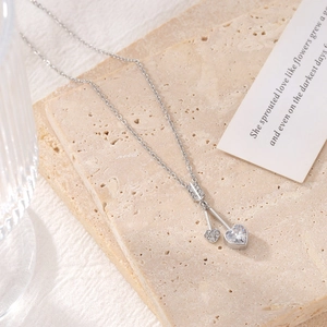 Elegant silver heart pendant necklace with zircon stone on a stylish marble background