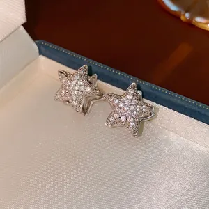 Sparkling silver star earrings with pavé zircon crystals, versatile luxury design for women