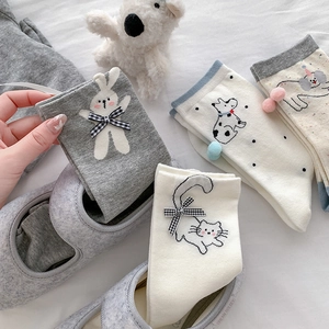 Cute mid-calf cartoon animal socks with bows and pom-poms in white and grey colors