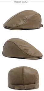 Detail view of brown PU leather beret showing side vents and adjustable metal buckle strap