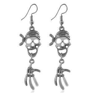 Macro detail of gothic skull pirate earrings with skeletal hand drops in antique silver