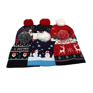 Winter knitted Christmas beanies with pom-poms featuring Santa, reindeer, and snowflakes