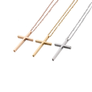 Three minimalist stainless steel cross necklaces in gold, silver, and rose gold finish