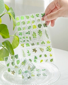 Macro detail of transparent 3D leaf stickers showing green clover and fern patterns