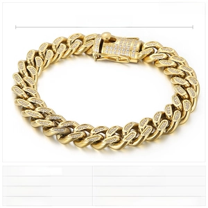 Detailed view of a 12mm wide gold-tone Cuban link bracelet with clear cubic zirconia stones