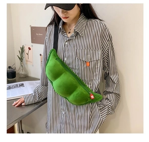 Close-up of a creative pea pod plush shoulder bag in vibrant green with a black strap