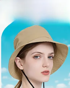 Detail of a beige sun hat with wide brim and black chin strap for outdoor protection