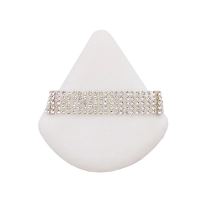 Elegant multi-row silver sparkling rhinestone bracelet displayed on a white stand