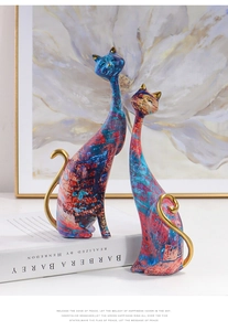 Close-up of artistic water transfer graffiti texture on abstract resin cat figurines