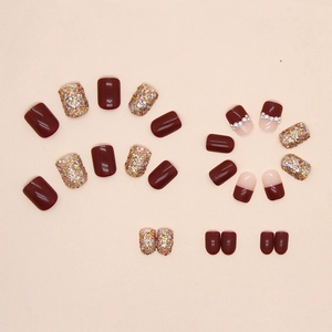 Burgundy glitter press-on nails set with pearls and sequins for festive holiday looks